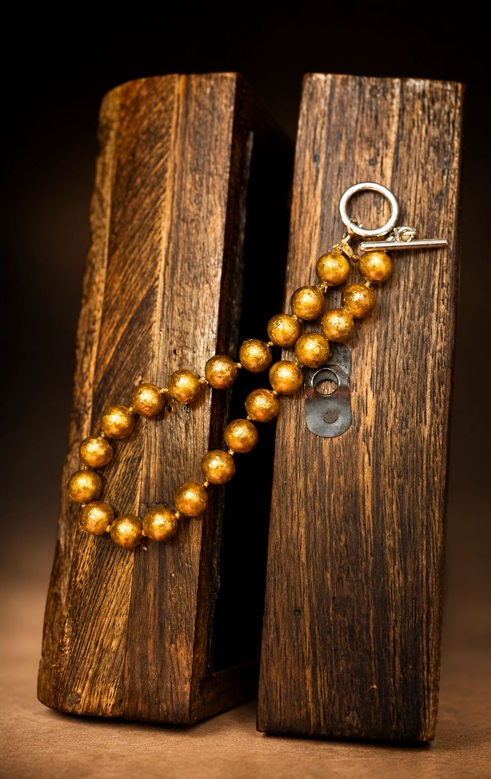 Bracelet of pearls finished in our secret lacquered gold colour-building technique with a T-bar clasp